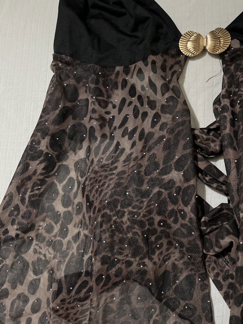 Shein Leopard Print Mesh Halter Top with Shell Buckle (Category: Sleeveless) located in Quezon City. Submitted by getitrightaway.ph (Listing ID 1466070251, Image 3). Description: - Brand: Shein - Design: Solid black upper with leopard print sheer mesh lower section - Details: Sparkly rhinestones scattered on mesh & gold-tone shell-shaped front buckle - Closure: Halter neck tie and adjustable back tie - Hemline: Asymmetrical handkerchief hem - Mat