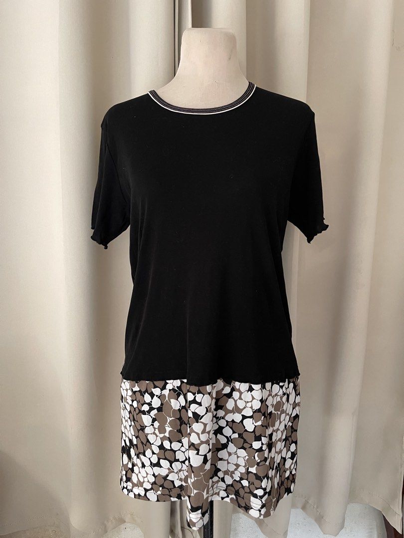 shirt dress (Category: Dresses) located in Cainta. Submitted by zlove111 (Listing ID 1466108791, Image 1). Description: - Color: Black top with white, brown, and black floral/leaf pattern on the bottom layer - Features: Striped ribbed neckline, lettuce hem cuffs, and attached layered design - Fabric: Lightweight and breathable cotton-blend - Styling: Perfect for pairing with denim jeans or skirts for a casual OOTD - Condition: Brand new and ready