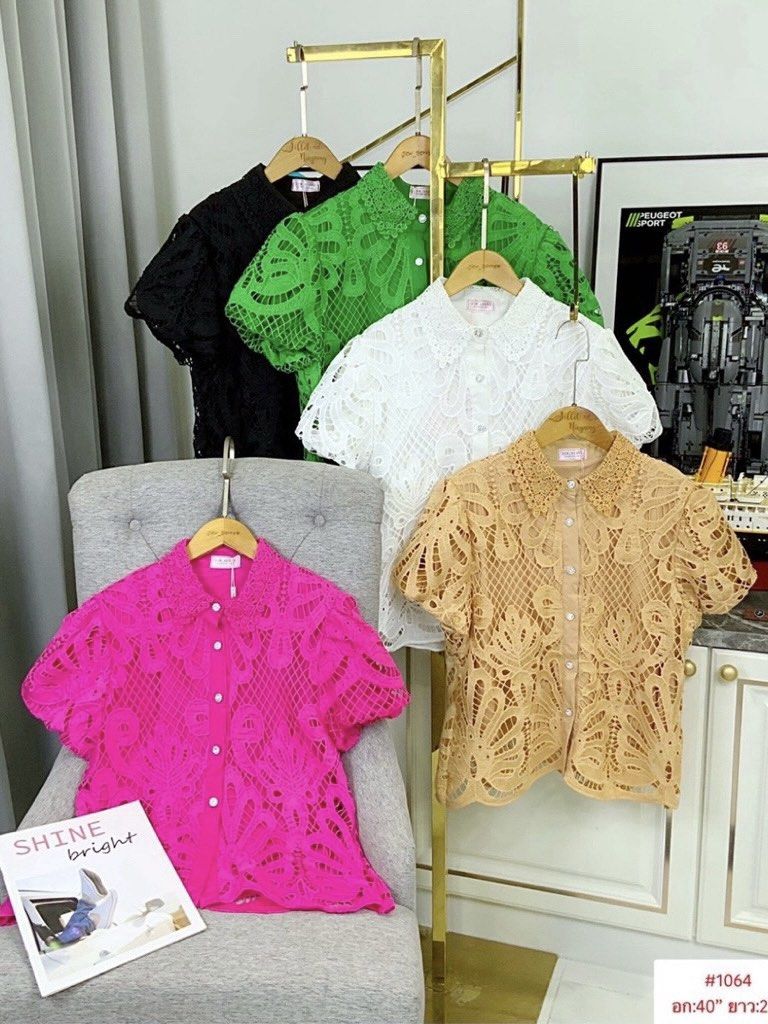 Short sleeve lace patterned button down blouse shirt (Category: Blouses) located in Paranaque City. Submitted by jujudeclutterss (Listing ID 1466149475, Image 1). Description: - Style: Short sleeve lace shirt with button-front closure and classic collar - Design: Intricate openwork pattern with detailed floral motifs - Material: Lightweight, breathable fabric with matching buttons - Colors Available: Hot pink, beige, white, green, and black - Ver