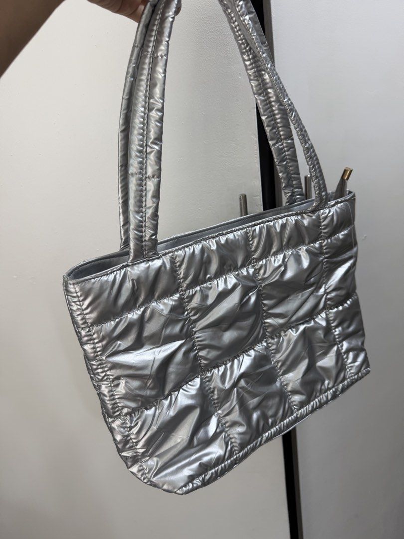 Silver Puffer Tote Bag Quilted Shoulder Bag (Category: Tote Bags) located in Pasig City. Submitted by miss_abuelita (Listing ID 1465988707, Image 2). Description: - Trendy quilted silver tote bag with a gorgeous puffy metallic finish - Double shoulder straps for comfortable daily wear - Secure zip top closure to keep your essentials safe - Soft padded material that is ultra-lightweight yet very roomy - Versatile everyday shoulder bag, perfect for