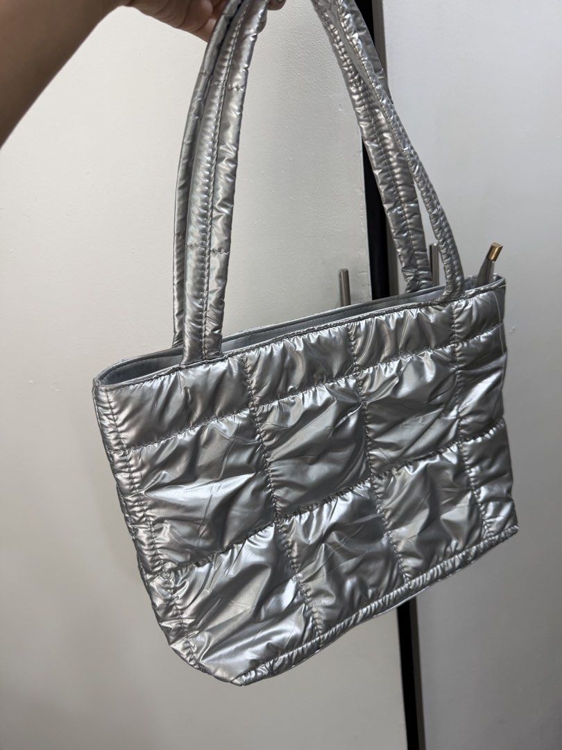 Silver Puffer Tote Bag Quilted Shoulder Bag (Category: Tote Bags) located in Pasig City. Submitted by miss_abuelita (Listing ID 1465988707, Image 3). Description: - Trendy quilted silver tote bag with a gorgeous puffy metallic finish - Double shoulder straps for comfortable daily wear - Secure zip top closure to keep your essentials safe - Soft padded material that is ultra-lightweight yet very roomy - Versatile everyday shoulder bag, perfect for