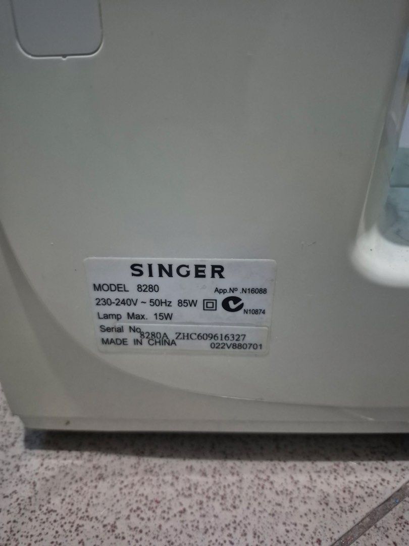 Singer Sewing Machine Model 8280 (Category: Art & Prints) located in Manila. Submitted by munggomooo (Listing ID 1466024648, Image 2). Description: - Brand/Model: Singer 8280 Sewing Machine - Power: 230-240V, 50Hz, 85W (Built-in light up to 15W) - Features: Multiple stitch selection dials and convenient reverse lever - Condition: Fully functional with some cosmetic scuffs and marks on the plastic casing from previous storage and usage.