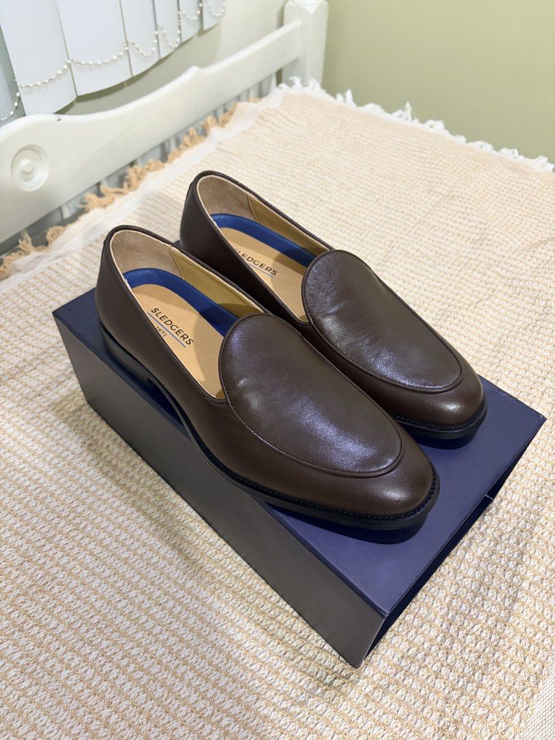 Sledgers Henri Loafers (Category: Dress Shoes) located in Cebu City. Submitted by xxxcclx (Listing ID 1465990031, Image 1). Description: - Brand: Sledgers 1921 - Item: Brown leather slip-on dress shoes / loafers - Condition: Brand new, never worn, pristine inside packaging - Features: Classic clean look with ultra-comfortable cushioned blue insoles - Inclusions: Complete with original branded dark blue box and individual dust bags.
