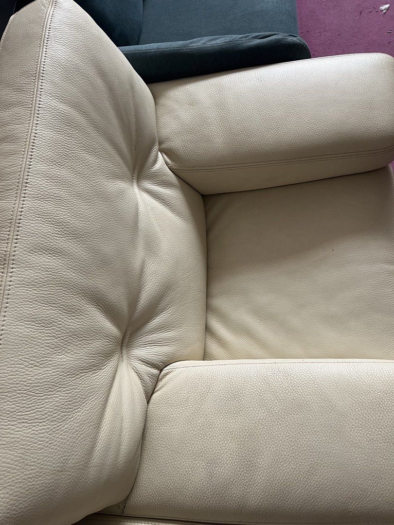 Sofa (Category: Sofas) located in Singapore. Submitted by ah__fei (Listing ID 1465980366, Image 3). Description: - Cream-colored leather sofa with a chic pebble grain texture - Elegant tufted backrest featuring pull-in details on both sides - Wide armrests and trendy woven wicker-style lower base panels - Solid construction paired with thick, ultra-comfortable seat cushions - Neutral tones designed to complement any living room interior.