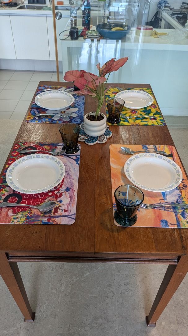 Solid Wood Dining Table (Category: Tables & Sets) located in Singapore. Submitted by haanbun (Listing ID 1465969557, Image 1). Description: - Material: Solid wood with natural grain patterns and knots - Design: Sturdy rectangular top with tapered legs and rich brown finish - Condition: Minor wear on the leg base from daily use - Dimensions: 120cm x 73 x 77 *Decorated for illustration only. Decor not included*.