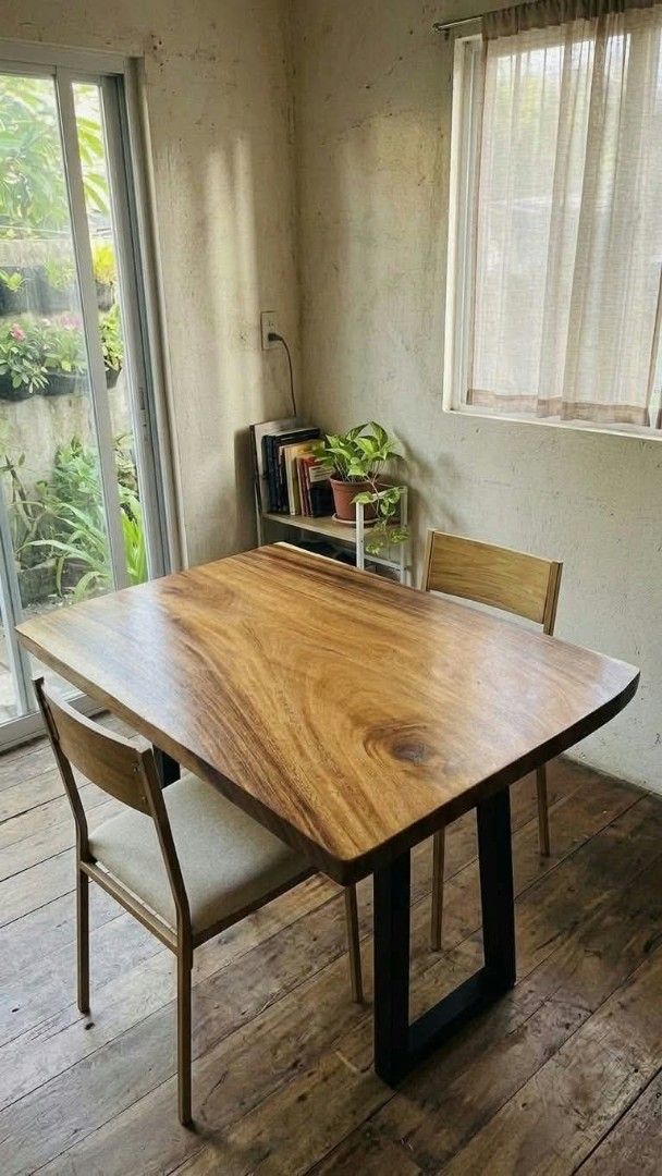 Solid Wood Live Edge Dining Table with Metal Legs (Category: Tables & Sets) located in Quezon City. Submitted by sebastianjay22 (Listing ID 1465953919, Image 1). Description: - Material: Solid wood slab with natural live edge and rich grain patterns - Base: Sturdy black metal trapezoid legs - Size: 4 seater - Condition: Heavy, durable, and well-constructed - Style: Natural wood tones, perfect for modern or rustic interiors.