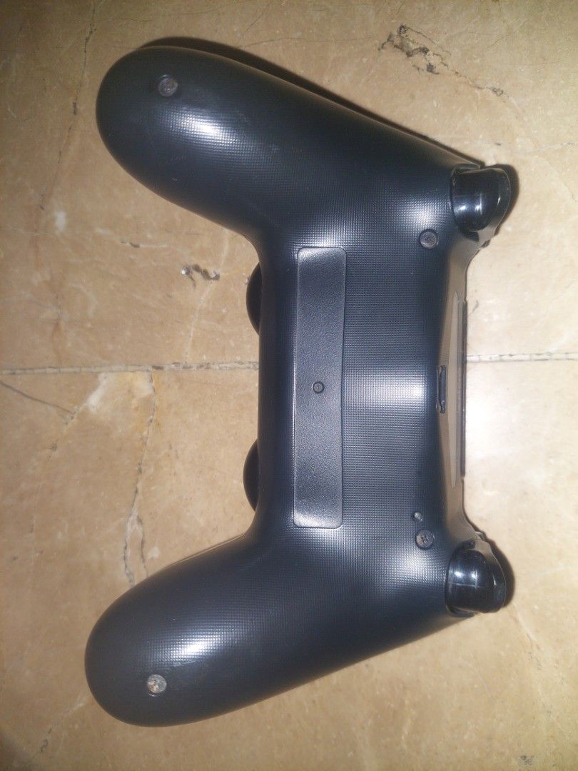 Sony PlayStation 4 DualShock 4 Wireless Controller (Category: Controllers) located in Pasig City. Submitted by ybarralucas05 (Listing ID 1466031186, Image 2). Description: - Color: Classic Black - Compatibility: Works seamlessly with all PS4 consoles - Comfort: Features textured grips on the handles for better control during long gaming sessions - Layout: Standard design with dual analog sticks, directional pad, and tactile action buttons - Conne
