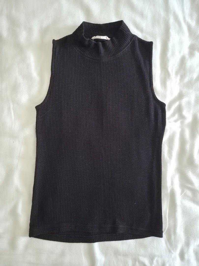Stradivarius Black Ribbed Turtleneck Tank Top (Category: Sleeveless) located in Quezon City. Submitted by corrnic (Listing ID 1466031275, Image 2). Description: - Brand: Stradivarius - Size: EUR M / USA M / MEX 28 - Color: Classic Black - Material: Comfortable ribbed knit fabric - Fit: Fitted silhouette, great for layering or solo wear - Style: Minimalist and easy to match with high-waist jeans or skirts - Condition: Clean, excellent pre-loved co