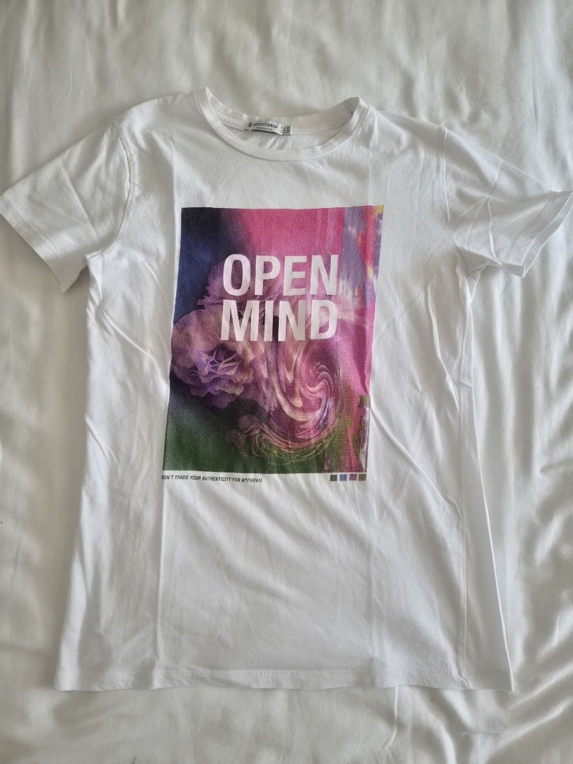 Stradivarius Open Mind Graphic White T-shirt (Category: Shirts) located in Quezon City. Submitted by corrnic (Listing ID 1466030453, Image 2). Description: - Brand: Stradivarius - Size: XS - Color: Clean White - Design: Colorful abstract graphic with 'OPEN MIND' text and quote - Details: Short sleeves, round neckline - Origin: Made in Egypt - Condition: Great for simple casual wear.