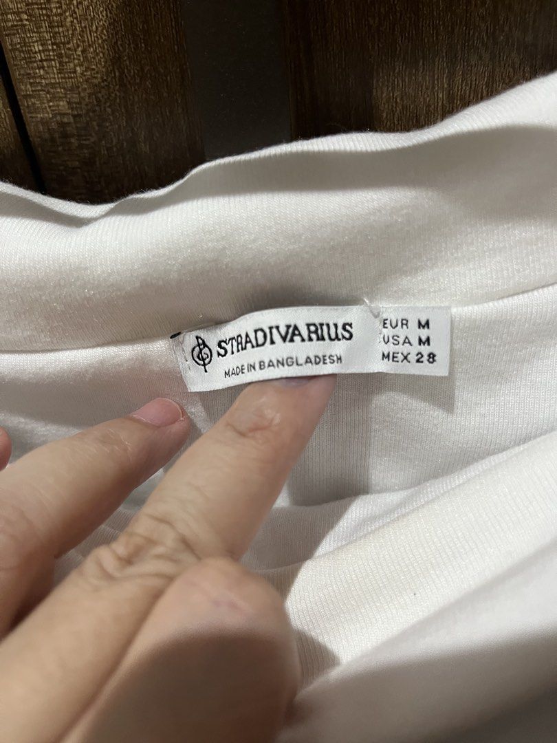 Stradivarius White Off-Shoulder Long Sleeve Top (Category: Longsleeves) located in Quezon City. Submitted by epictiger.c6451a (Listing ID 1465966450, Image 2). Description: - Brand: Stradivarius - Color: White - Size: M - Material: Soft ribbed cotton - Origin: Made in Bangladesh - Style: Foldover off-shoulder neckline, long sleeves - Perfect basic piece for casual everyday wear - Condition: Excellent / Like new.