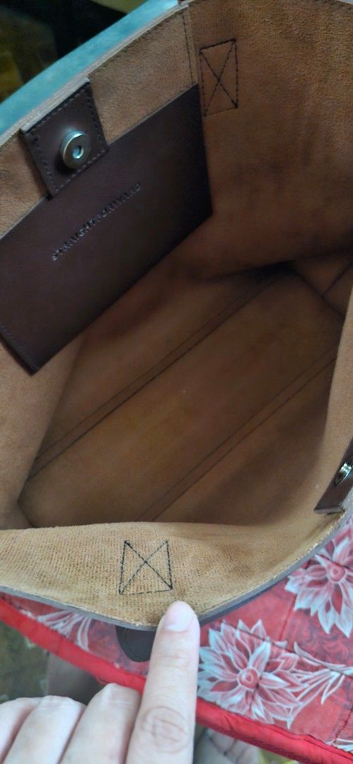 Straightforward Brown Leather Tote Bag (Category: Tote Bags) located in Quezon City. Submitted by gnelsky (Listing ID 1465994110, Image 3). Description: - Color: Brown - Material & Interior: Sturdy exterior with a spacious tan suede lining - Closure: Secure magnetic button closure - Features: Minimal front branding, double handle straps, and a convenient internal slip pocket - Condition: Clean interior, well-maintained - Best for: Everyday use fo
