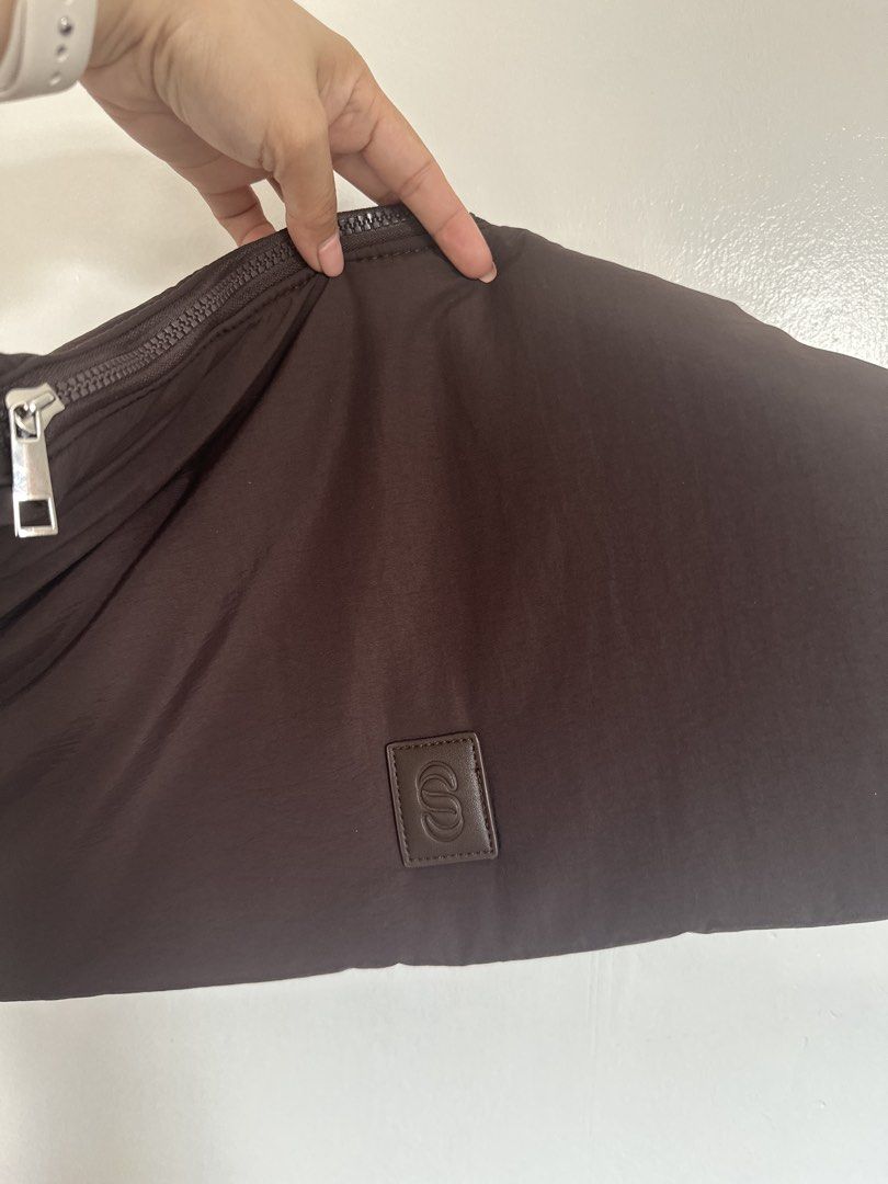 Straightforward Wylan Sling in Chestnut (Category: Shoulder Bags) located in Cainta. Submitted by xyzasisa (Listing ID 1465996533, Image 2). Description: - Color: Chestnut Brown - Material: Lightweight nylon with clean interior and exterior - Strap: Thick braided rope with silver hardware details - Closure: Secure main zip closure along the top - Details: Small square leather logo patch with letter design on the bottom front Dimension: -Length: b
