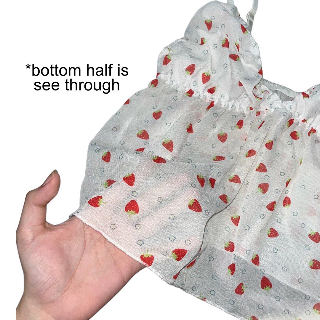Strawberry Print Sheer Camisole/Cami Top with Light Padding (Category: Sleeveless) located in Liliw. Submitted by virgbaby0 (Listing ID 1466025403, Image 2). Description: super cute coquette / y2k strawberry print cami top 🍓✨ gives major soft girl ! *bottom half is lightweight see-through chiffon fabric, chest area is lined / lightly padded with adjustable straps so it’s super easy to wear - Design: White camisole with red strawberry prints and 