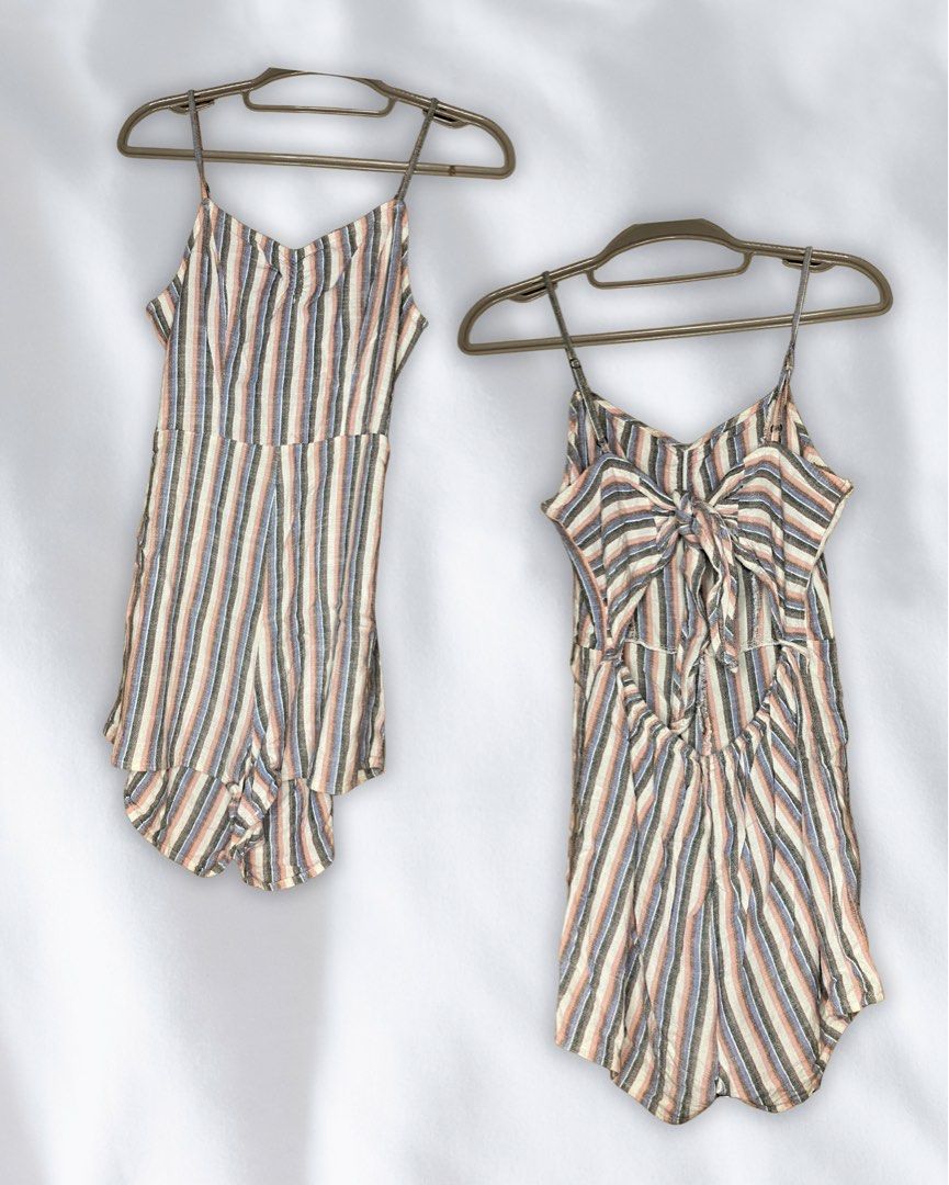 Striped Spaghetti Strap Romper with Back Bow Detail (Category: Rompers) located in Roxas City. Submitted by mariellaann_ (Listing ID 1466001758, Image 1). Description: - Bought in the US 🇺🇸 - Design: Multi-colored vertical stripes (pink, black, blue, and cream) - Details: Spaghetti straps and adjustable tie-back bow - Fabric: Lightweight and travel-friendly, perfect for the beach or weekends - Condition: Clean, well-kept, and ready to wear.