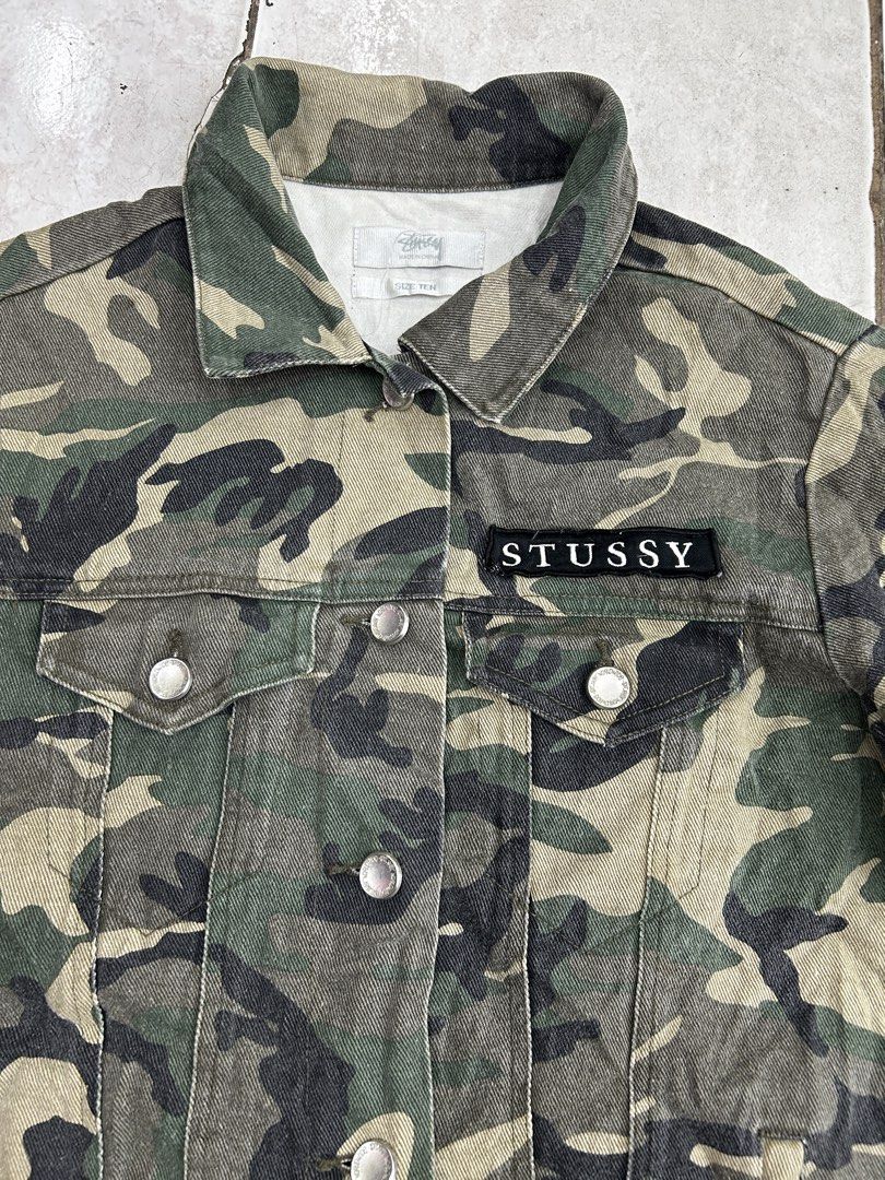 Stüssy Camouflage Leopard Back Jacket Size 10 (Category: Coats, Jackets and Outerwear) located in Cebu City. Submitted by jkeive (Listing ID 1465989709, Image 3). Description: - Brand: Stüssy - Size: 10 - 20x25 Dimension - Design: Camo denim with button-up front and collar neckline - Details: Black Stüssy text patch on right chest, buttoned cuffs - Back: Large leopard graphic printed on a dark panel - Origin: Made in China - Condition: Excellent 