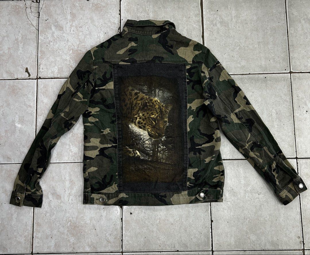 Stüssy Camouflage Leopard Back Jacket Size 10 (Category: Coats, Jackets and Outerwear) located in Cebu City. Submitted by jkeive (Listing ID 1465989709, Image 2). Description: - Brand: Stüssy - Size: 10 - 20x25 Dimension - Design: Camo denim with button-up front and collar neckline - Details: Black Stüssy text patch on right chest, buttoned cuffs - Back: Large leopard graphic printed on a dark panel - Origin: Made in China - Condition: Excellent 