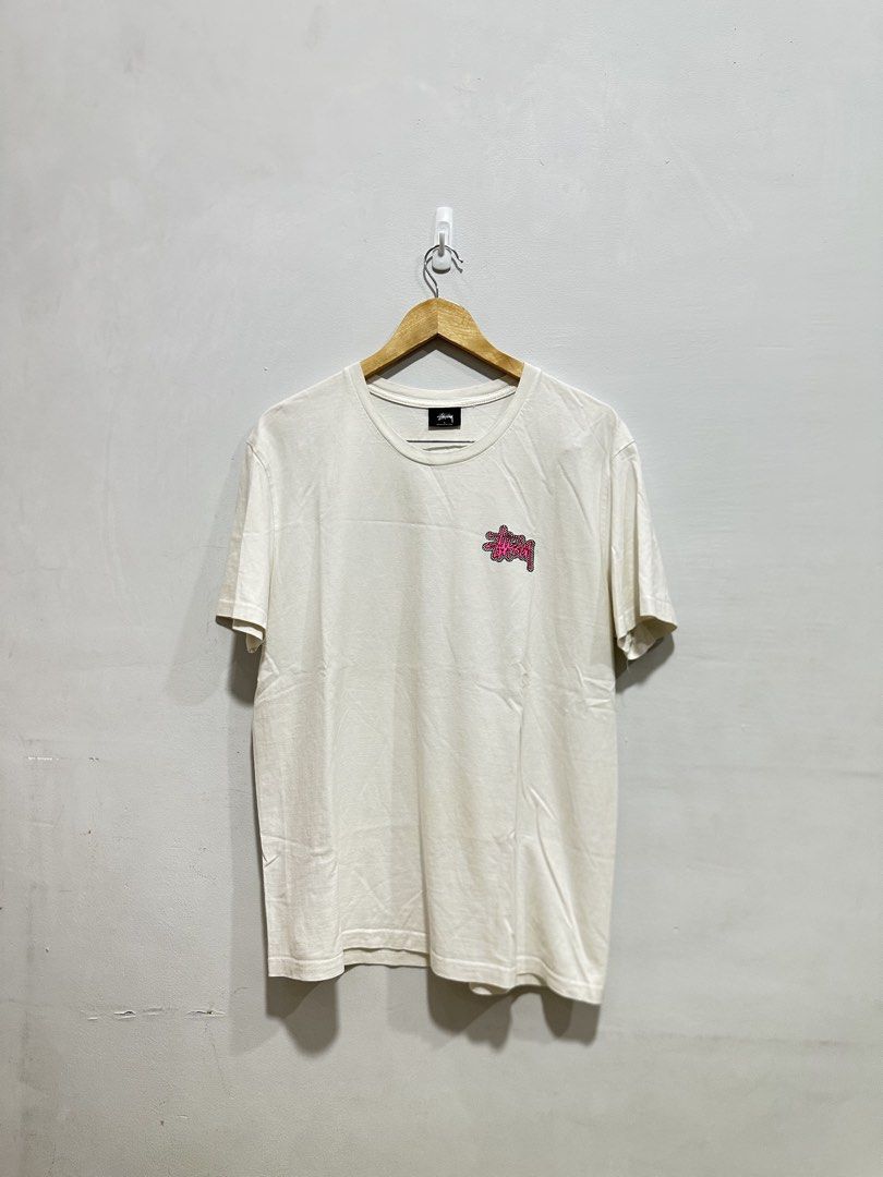 Stüssy Checkerboard Graphic Tee White Pink L (Authentic) (Category: Tshirts & Polo Shirts ) located in Manila. Submitted by ylsrarities (Listing ID 1465992169, Image 1). Description: • Made in Mexico • Size Large • Measurements: 22Wx28L • “NEW YORK LOS ANGELES LONDON PARIS TOKYO” text • Original Stüssy neck and care labels • RN 94974 / CA 28629 • Guaranteed Legit/Authentic, Money back if proven fake Condition: 8/10 Pre-owned with normal signs of 