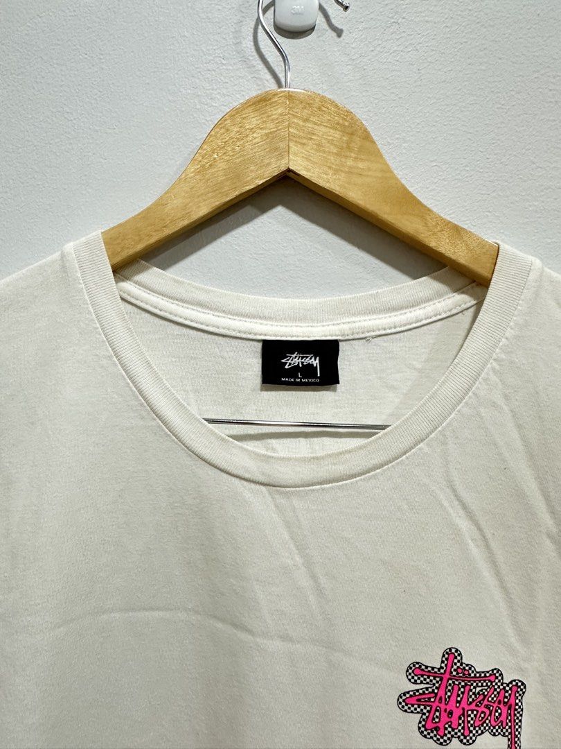 Stüssy Checkerboard Graphic Tee White Pink L (Authentic) (Category: Tshirts & Polo Shirts ) located in Manila. Submitted by ylsrarities (Listing ID 1465992169, Image 3). Description: • Made in Mexico • Size Large • Measurements: 22Wx28L • “NEW YORK LOS ANGELES LONDON PARIS TOKYO” text • Original Stüssy neck and care labels • RN 94974 / CA 28629 • Guaranteed Legit/Authentic, Money back if proven fake Condition: 8/10 Pre-owned with normal signs of 
