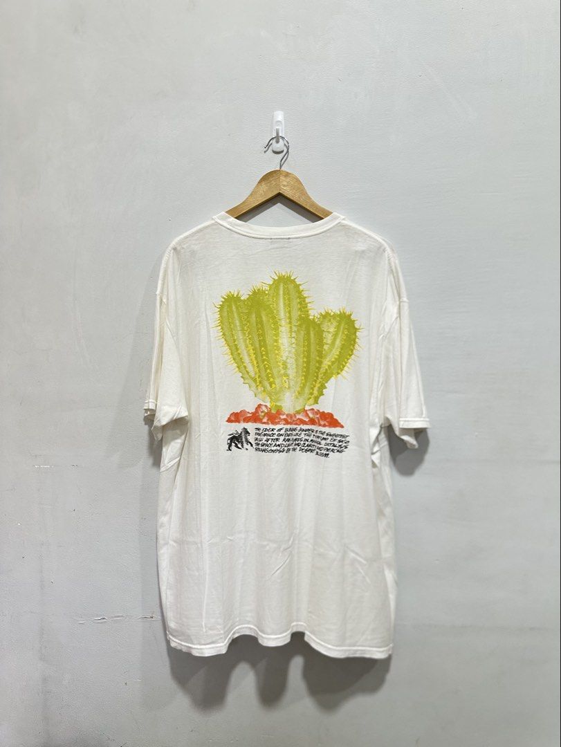 Stüssy Desert Bloom Tee White XL (Authentic) (Category: Tshirts & Polo Shirts ) located in Manila. Submitted by ylsrarities (Listing ID 1466093437, Image 1). Description: Pre-owned with normal signs of wear. The fabric remains clean and comfortable with plenty of life left. The cactus graphics remain vibrant and intact with no major cracking or fading visible. The tee has a wide, slightly oversized fit typical of this model. • Brand: Stüssy • Mod
