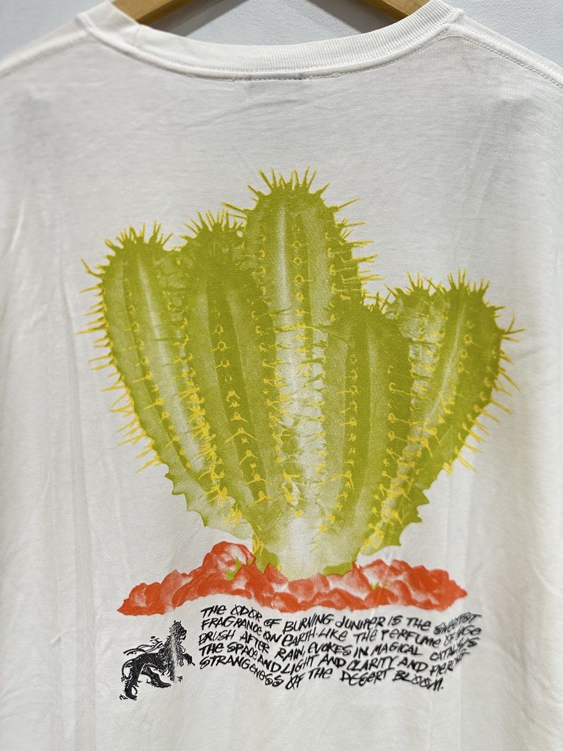 Stüssy Desert Bloom Tee White XL (Authentic) (Category: Tshirts & Polo Shirts ) located in Manila. Submitted by ylsrarities (Listing ID 1466093437, Image 2). Description: Pre-owned with normal signs of wear. The fabric remains clean and comfortable with plenty of life left. The cactus graphics remain vibrant and intact with no major cracking or fading visible. The tee has a wide, slightly oversized fit typical of this model. • Brand: Stüssy • Mod