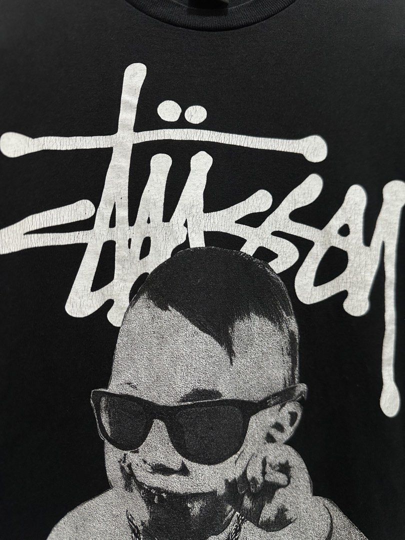 Stussy (Category: Tshirts & Polo Shirts ) located in Manila. Submitted by ylsrarities (Listing ID 1465993934, Image 3). Description: Pre owned with natural signs of age and wear. Graphic shows visible cracking and consistent with an older Stüssy tee. Black body has some general fading and fabric wear. No major holes or tears noted. • Size M • Measurements: 20Wx 27.5L • Stüssy branding • Short sleeve crewneck • 100% cotton • Assembled in Mexico of