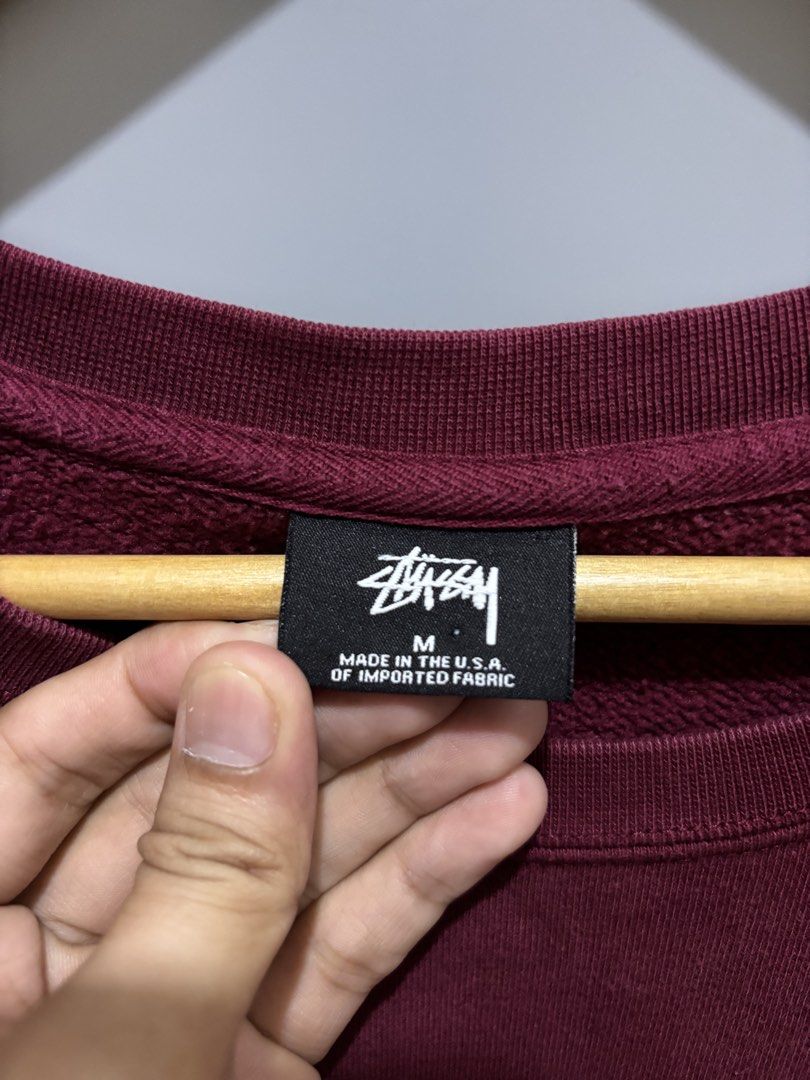 STUSSY BASIC LOGO CREWNECK (Category: Coats, Jackets and Outerwear) located in Bayambang. Submitted by lo_keythrifting (Listing ID 1465993456, Image 3). Description: - Brand: Stussy - Condition: Excellent condition - Dimes: 20*26 - Color rate: 9.8/10 - Issue: Minimal scratch see last pic - Color: Maroon - Size: Medium - Material: 100% Cotton, Made in USA - Design: Small white logo on left chest, oversized Stussy logo on back - Style: Crewneck wit