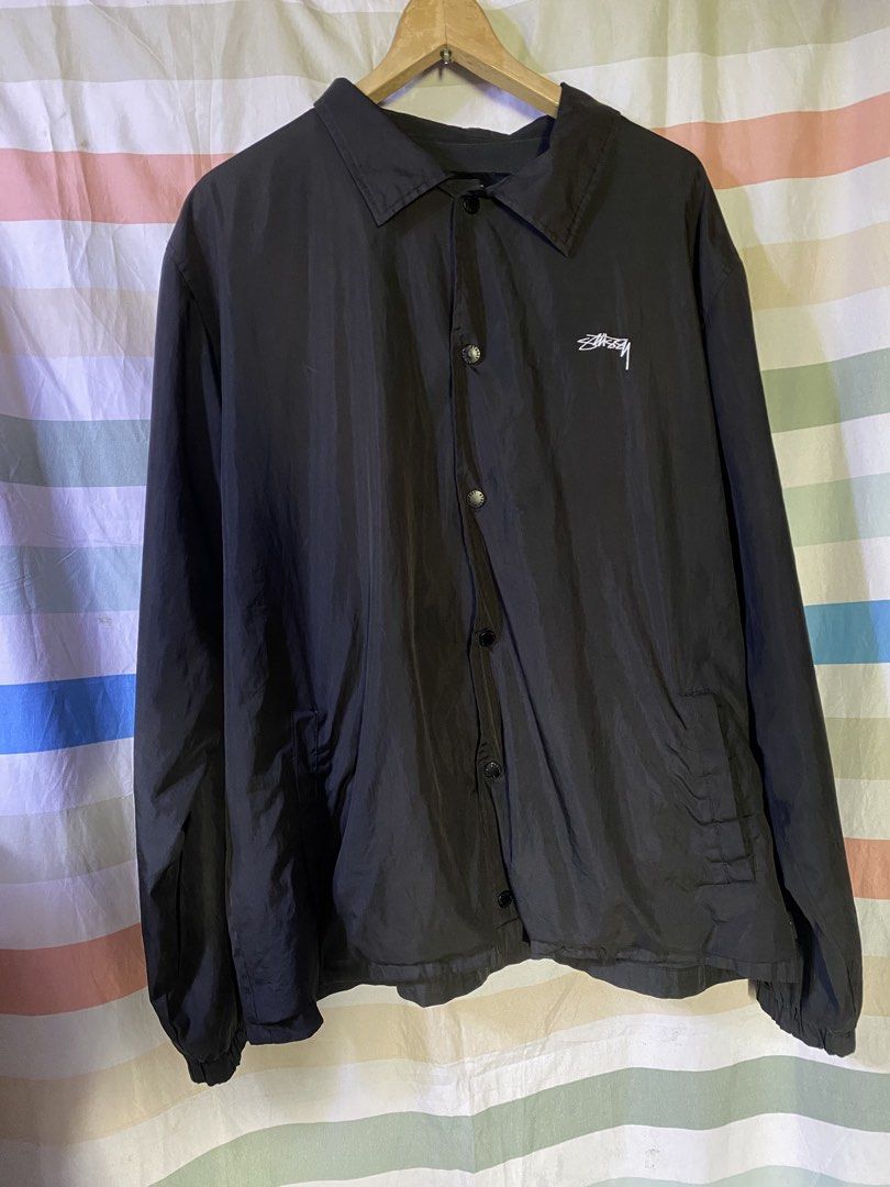 Stussy Black Coaches Jacket Size XL (Category: Coats, Jackets and Outerwear) located in Manila. Submitted by kentmarion.water (Listing ID 1465962454, Image 1). Description: - Authentic Stussy coaches jacket in clean condition - Color: Black with white Stussy logos on chest and back - Closure: Button snap with functional side pockets - Materials: 100% polyester shell, comfortable cotton body lining, and polyester sleeve lining - Fit: Standard fit,