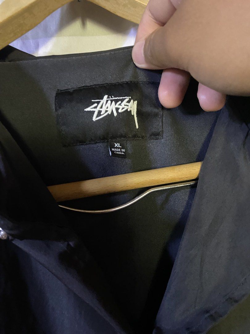 Stussy Black Coaches Jacket Size XL (Category: Coats, Jackets and Outerwear) located in Manila. Submitted by kentmarion.water (Listing ID 1465962454, Image 3). Description: - Authentic Stussy coaches jacket in clean condition - Color: Black with white Stussy logos on chest and back - Closure: Button snap with functional side pockets - Materials: 100% polyester shell, comfortable cotton body lining, and polyester sleeve lining - Fit: Standard fit,