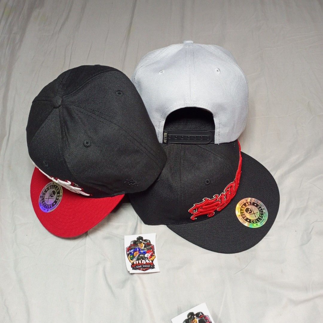 Sullen Art Collective Snapback Caps (Category: Caps & Hats) located in General Santos City (Dadiangas). Submitted by nonoks1234 (Listing ID 1465956137, Image 3). Description: Three Sullen Art Collective snapback caps available. Classic flat brim styles with detailed embroidery on the front and custom tattoo art graphics printed underneath the brims. Adjustable plastic snapback closure at the back for a custom fit. One size fits most. Clean condit