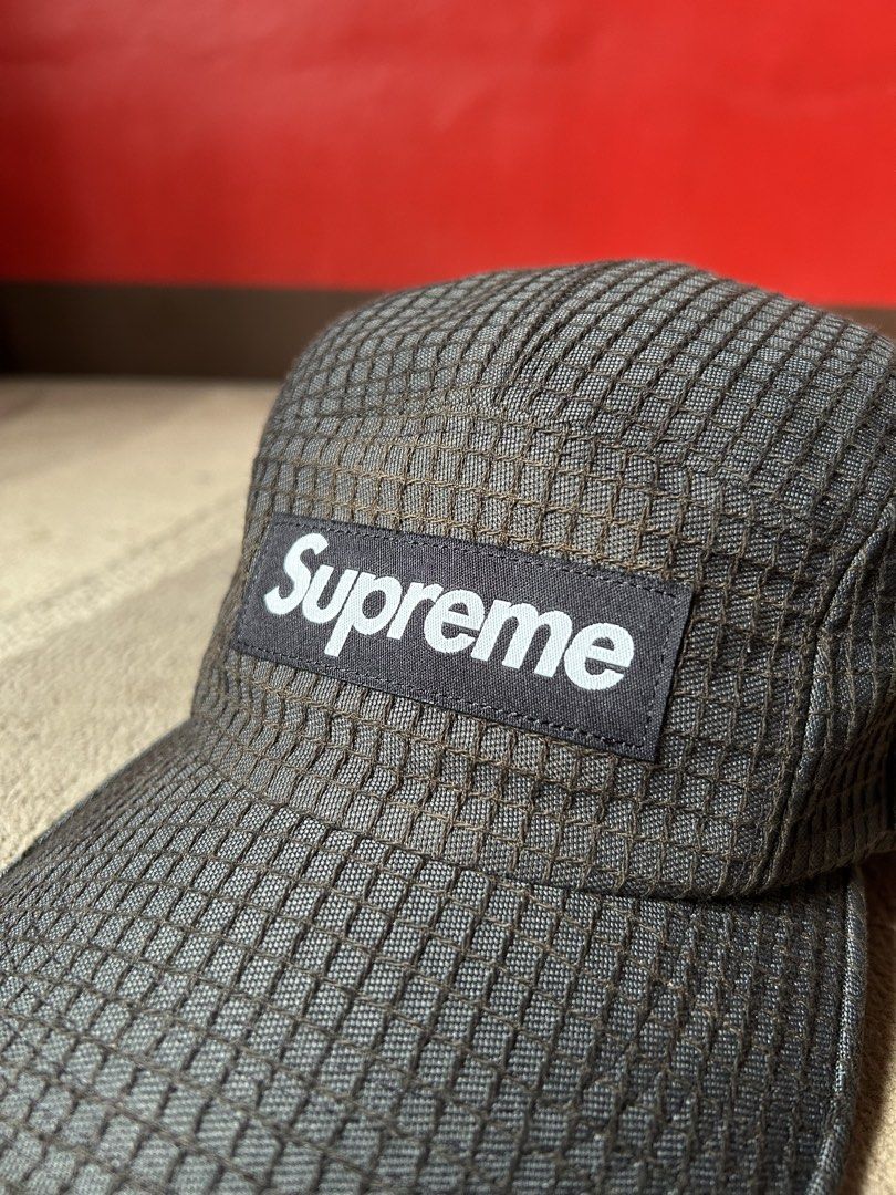 Supreme Ripstop Camp Cap Black (Category: Caps & Hats) located in Abucay. Submitted by stuttt (Listing ID 1465978492, Image 2). Description: - Brand: Supreme - Style: 5-panel camp cap - Material/Design: Dark grid texture fabric with structured crown - Branding: Classic box logo on front - Closure: Adjustable strapback with branded buckle - Condition: Clean interior lining, great everyday streetwear piece.