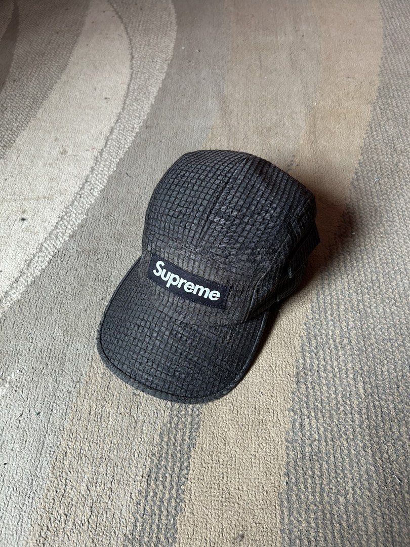Supreme Ripstop Camp Cap Black (Category: Caps & Hats) located in Abucay. Submitted by stuttt (Listing ID 1465978492, Image 1). Description: - Brand: Supreme - Style: 5-panel camp cap - Material/Design: Dark grid texture fabric with structured crown - Branding: Classic box logo on front - Closure: Adjustable strapback with branded buckle - Condition: Clean interior lining, great everyday streetwear piece.