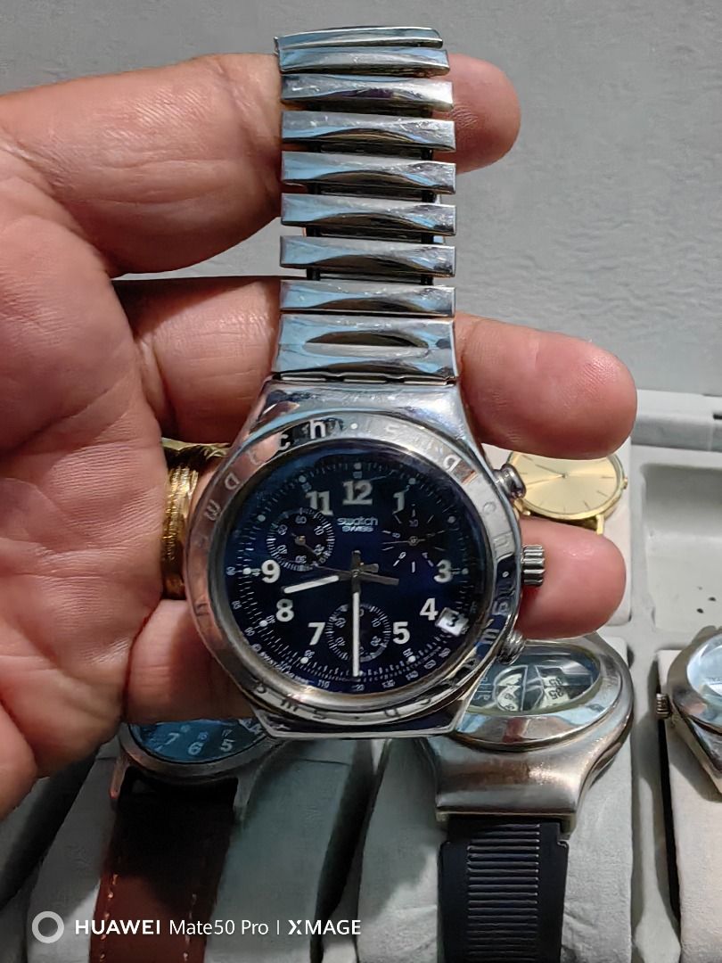 Swatch Swiss Chronograph Metal Watch (Category: Men's Watches) located in Manila. Submitted by lucky_yonathan (Listing ID 1466079365, Image 2). Description: - Brand: Swatch Chronograph Watch - Material: Stainless steel case and silver-tone metal bracelet with flexible links - Dial: Deep blue with 3 sub-dials and date window at 4 o'clock - Details: Bezel engraved with Swatch branding - Condition: Fully functional and keeps time properly, with visi
