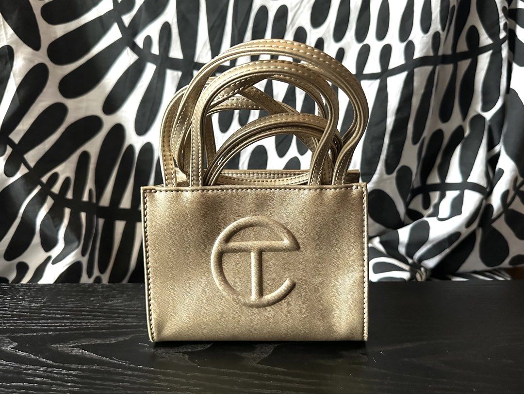 Authentic Telfar Small Shopping Bag Gold Metallic (Category: Luxury Bags & Wallets) located in Makati City. Submitted by teddymapa (Listing ID 1465970952, Image 1). Description: - Brand: Telfar - Style: Small Shopping Bag - Color: Gold Metallic - Material: Vegan Leather - Features: Double top handles, adjustable/removable crossbody strap, iconic embossed front logo - Capacity: Compact size, fits everyday essentials easily - Condition: Like new .