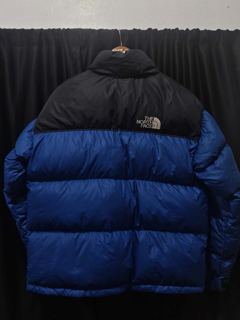 The North Face 700 Nuptse Puffer Jacket Blue Black (Category: Coats, Jackets and Outerwear) located in Baguio. Submitted by solo_ukay (Listing ID 1466101910, Image 2). Description: - Brand: The North Face - Style: Iconic blue and black puffer jacket - Insulation: Premium goose down with 700 fill power on the sleeve - Size: Women's Extra Large (XL) - Features: Full zip closure, stand collar, and embroidered logos on the chest and back - Material: 