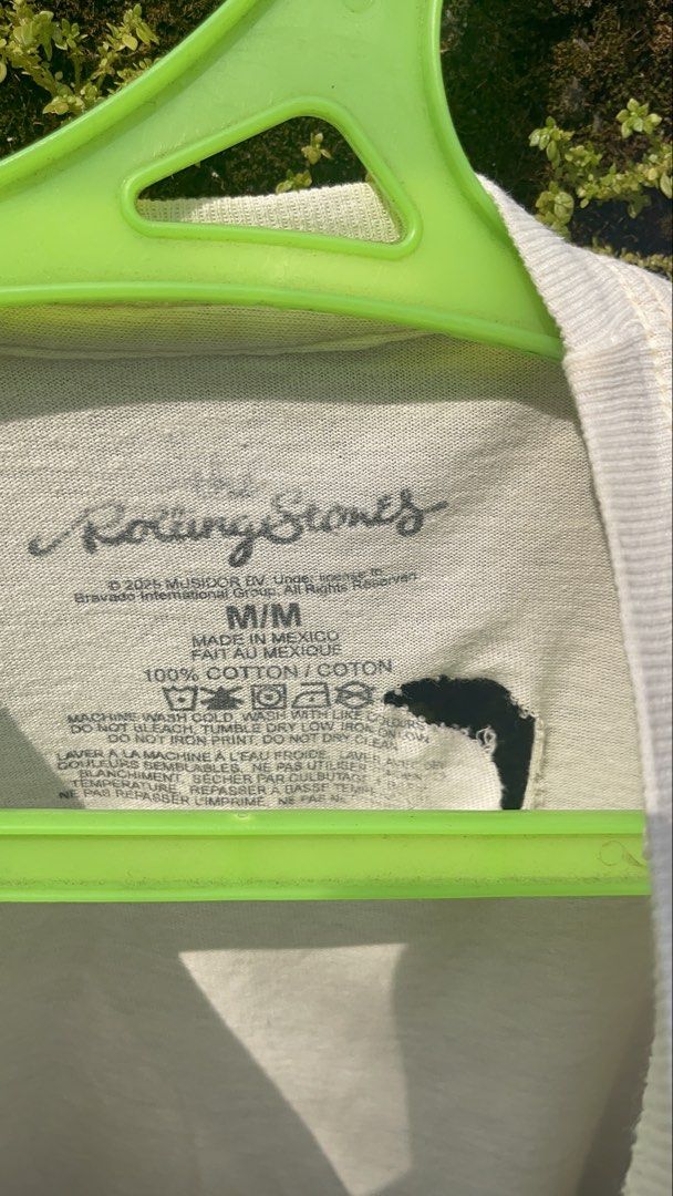 The Rolling Stones Graphic T-Shirt (Category: Tshirts & Polo Shirts ) located in Balanga. Submitted by death_vintage (Listing ID 1466015841, Image 3). Description: - Item: Official The Rolling Stones Graphic Tee - Brand/Merchandise: Bravado International Group (2025 Musidor BV) - Material: 100% Cotton, Made in Mexico - Size: Medium (printed inner collar tag) - Design: Multiple iconic tongue logos on white fabric - Condition: Flawed/Well-used, fea
