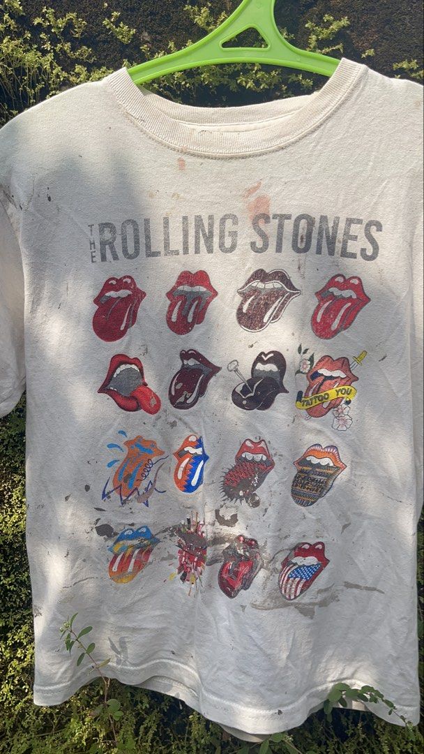 The Rolling Stones Graphic T-Shirt (Category: Tshirts & Polo Shirts ) located in Balanga. Submitted by death_vintage (Listing ID 1466015841, Image 2). Description: - Item: Official The Rolling Stones Graphic Tee - Brand/Merchandise: Bravado International Group (2025 Musidor BV) - Material: 100% Cotton, Made in Mexico - Size: Medium (printed inner collar tag) - Design: Multiple iconic tongue logos on white fabric - Condition: Flawed/Well-used, fea