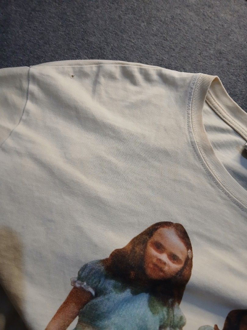 The Shining Graphic HORROR TEE (Category: Tshirts & Polo Shirts ) located in Caloocan City. Submitted by benthriftshp (Listing ID 1466120727, Image 3). Description: - Brand: Zara - Design: The Shining twins graphic print (front and back) - Color: Cream - Size: Medium (tag at collar) - Material: 100% Cotton, relaxed fit - Measurements: ~21" pit-to-pit, ~27" length - Flaw: Small pinhole near the right shoulder seam 850+sf.