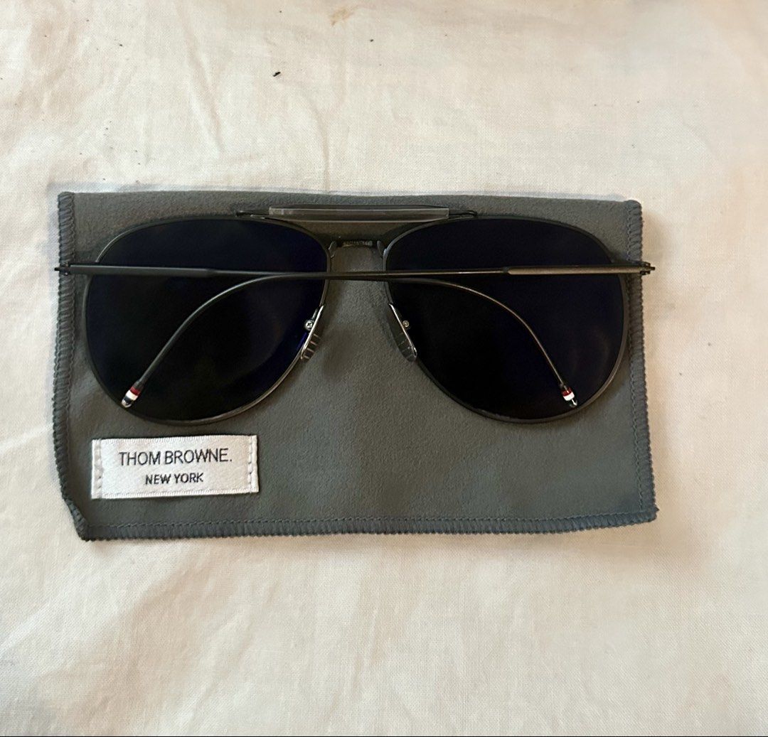 Thom Browne TB-015 LTD Black Grey Sunglasses (Category: Sunglasses & Eyewear) located in Makati City. Submitted by luchingching (Listing ID 1465993271, Image 3). Description: - Brand: Thom Browne - Model: TB-015 Aviator Sunglasses - Color: Black frame with dark grey lenses (subtle mirrored finish) - Design: Double bridge with signature tricolor red, white, and blue temple tips - Craftsmanship: Premium Japanese made luxury eyewear - Inclusions: Or