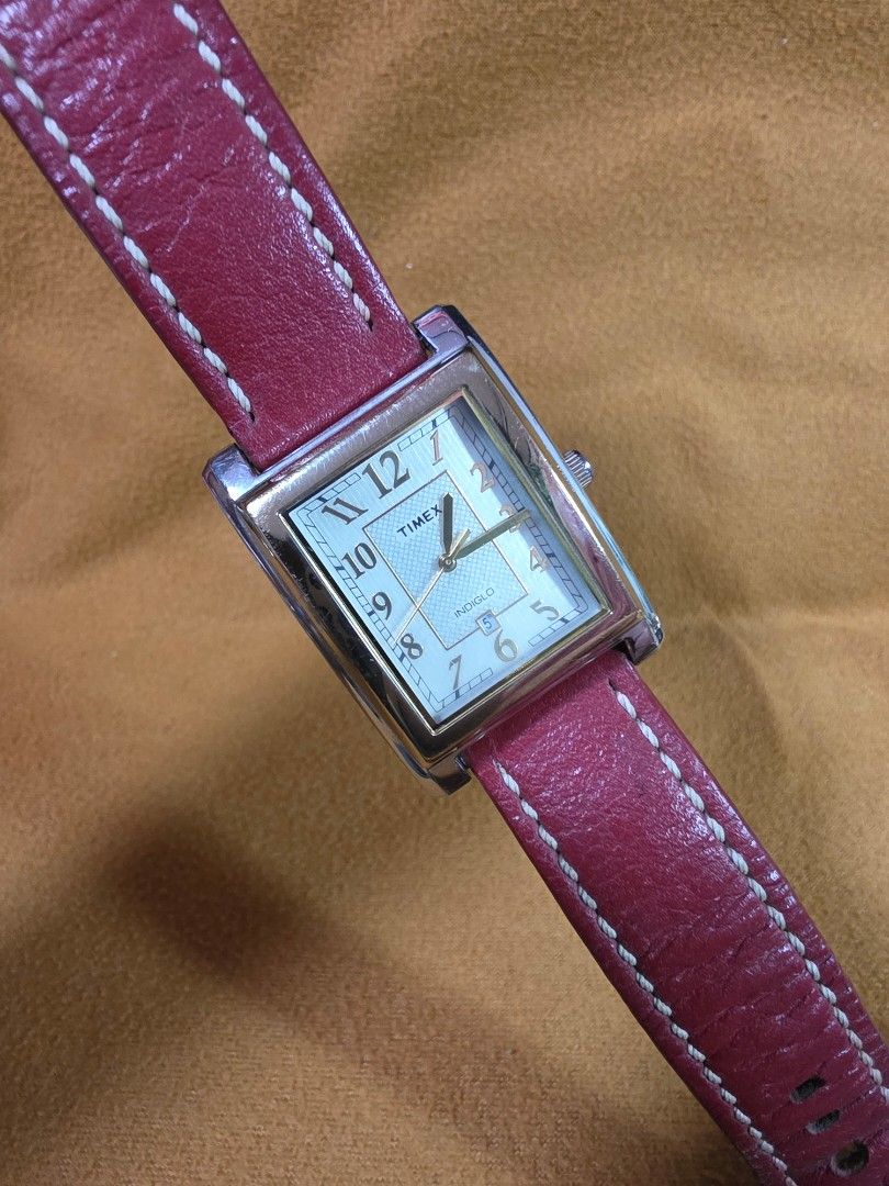 Timex Indiglo Rectangular Watch with Red Leather Strap (Category: Men's Watches) located in Rosales. Submitted by akumie30 (Listing ID 1466137194, Image 2). Description: - Brand: Timex - Case: Rectangular gold-tone with stainless steel back - Dial: Textured silver with date display at 6 o'clock - Lighting: Indiglo night-light feature - Strap: Genuine red leather with white contrast stitching - Battery: Uses CR 1216 cell battery Original Watch Wor
