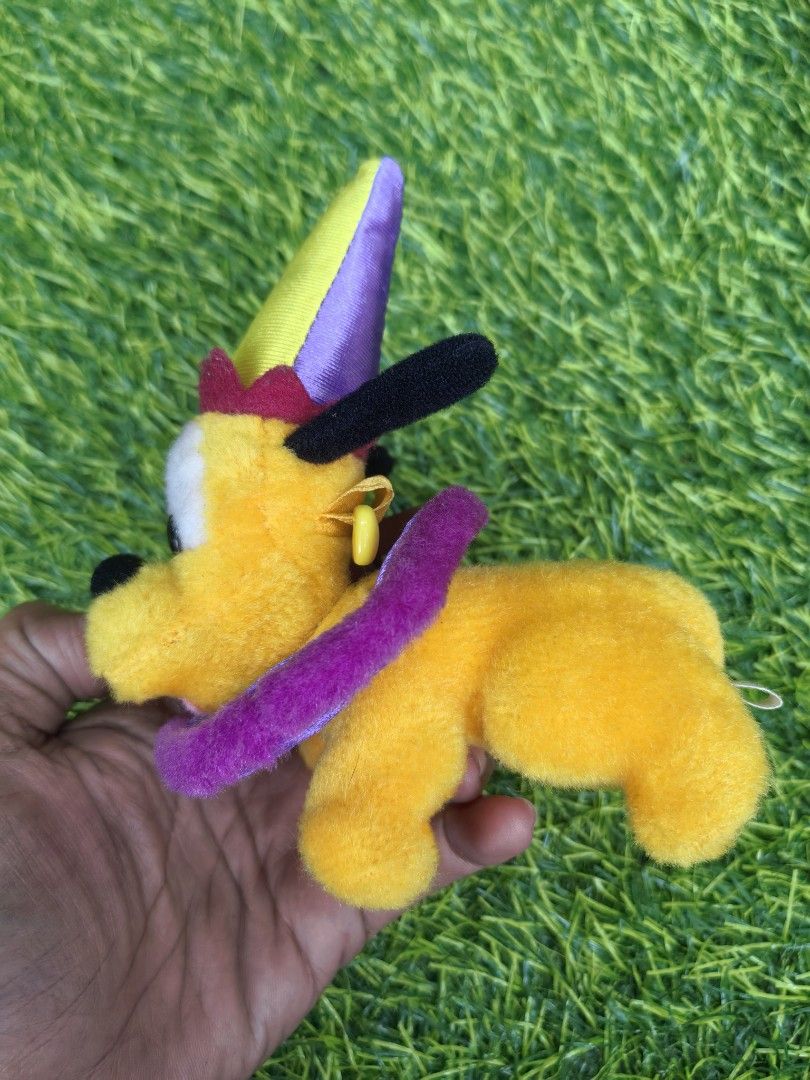 Tokyo Disneyland Pluto Jester Plush Toy (Category: Plushies & Soft Toys) located in Paranaque City. Submitted by furugiyafinds (Listing ID 1466045402, Image 2). Description: - Authentic Tokyo Disneyland Pluto plush toy - Dressed in a festive purple and yellow jester outfit with a working bell on the hat - Features a matching purple ruff collar, floppy black ears, and a cute sticking-out pink tongue - Original Tokyo Disneyland tag attached on the 