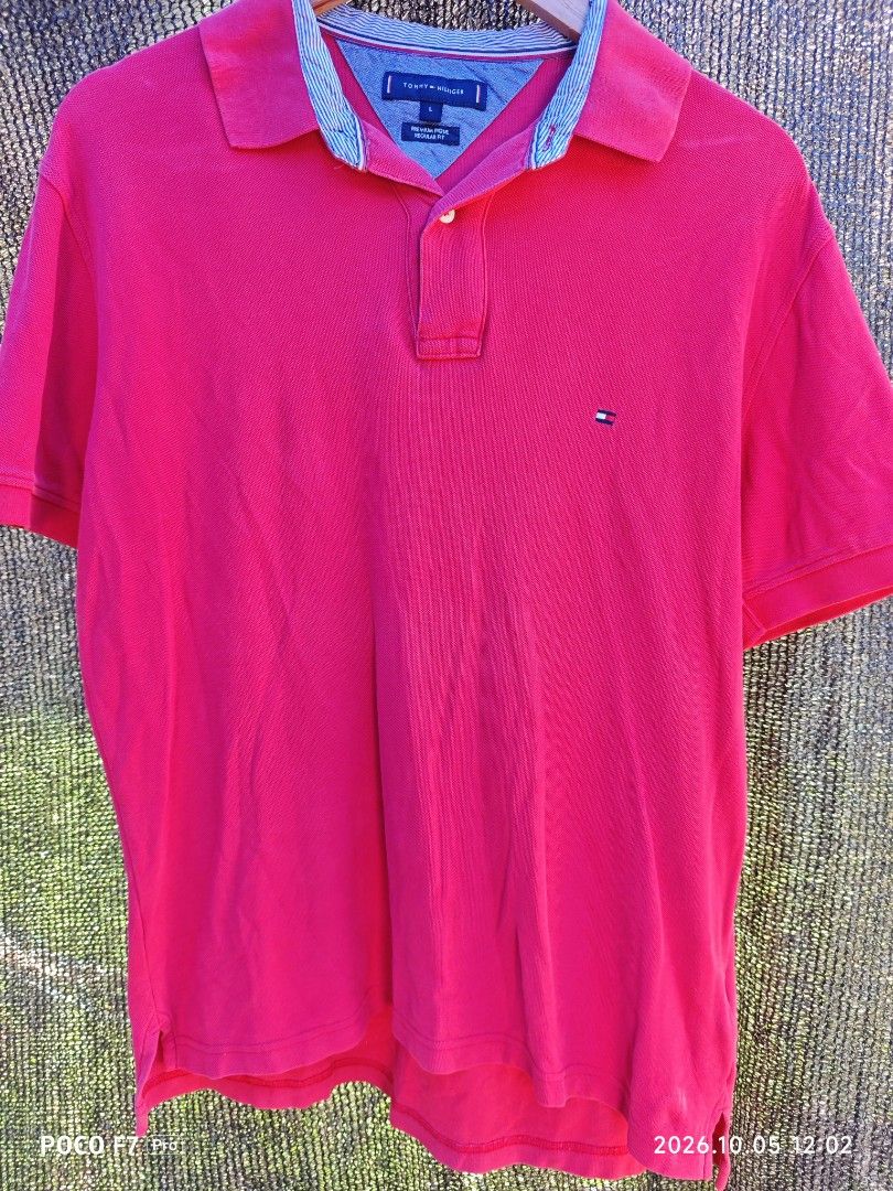 Tommy Hilfiger (Category: Activewear) located in Mexico. Submitted by josephnuqui1980 (Listing ID 1466127268, Image 1). Description: This is a bright fuchsia Tommy Hilfiger regular-fit pique polo in size L, accented with a contrasting blue-striped inner collar. Minor fade at the back see photos for details.