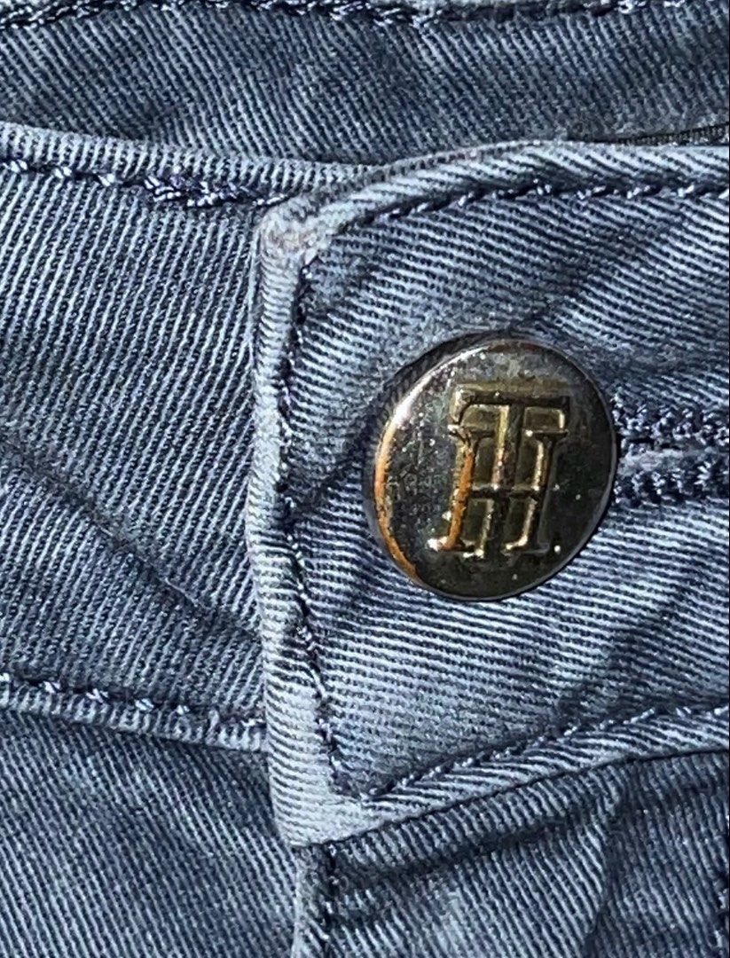 Tommy Hilfiger Dark Gray Jeans Size 4 (Category: Jeans) located in San Mateo. Submitted by cam__cao (Listing ID 1466033360, Image 3). Description: - Brand: Tommy Hilfiger - Color: Dark gray with a subtle washed finish - Size: 4 - Cut: Straight silhouette - Details: Classic five-pocket style, branded metal button closure, and leather logo patch - Condition: Excellent, perfect for everyday casual outfits •Button is a bit worn from use, but still fi