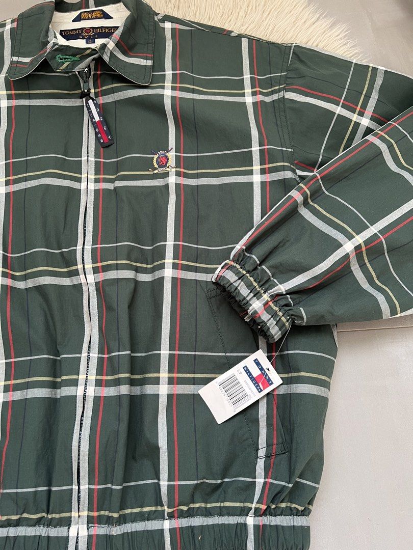 Tommy Hilfiger Golf Plaid Zip Jacket (Category: Coats, Jackets and Outerwear) located in Binan City. Submitted by finders_market (Listing ID 1465962516, Image 2). Description: - Brand: Tommy Hilfiger Golf - Style: Green plaid zip jacket with white contrast collar - Size: Men's Small - Material: 100% Cotton, Made in Malaysia - Details: Embroidered crest logo, branded zipper pull, two front pockets, elastic cuffs and hem - Condition: Brand new with