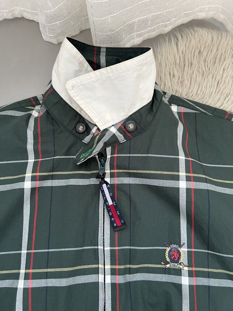Tommy Hilfiger Golf Plaid Zip Jacket (Category: Coats, Jackets and Outerwear) located in Binan City. Submitted by finders_market (Listing ID 1465962516, Image 3). Description: - Brand: Tommy Hilfiger Golf - Style: Green plaid zip jacket with white contrast collar - Size: Men's Small - Material: 100% Cotton, Made in Malaysia - Details: Embroidered crest logo, branded zipper pull, two front pockets, elastic cuffs and hem - Condition: Brand new with