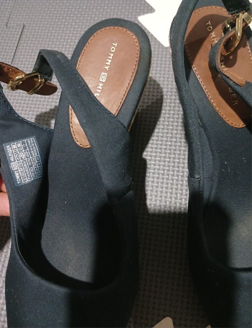 Tommy Hilfiger Navy Blue Wedge Sandals (Category: Sandals) located in Umingan. Submitted by mrobvariety (Listing ID 1465990125, Image 3). Description: - size: UK 3.5 - Brand: Tommy Hilfiger - Style: Open-toe wedge sandals with slingback strap and buckle closure - Color/Material: Navy blue canvas upper with dark brown leather details and woven jute platform - Details: Signature embroidered Tommy flag logo on the side - Fit/Condition: Comfortable f