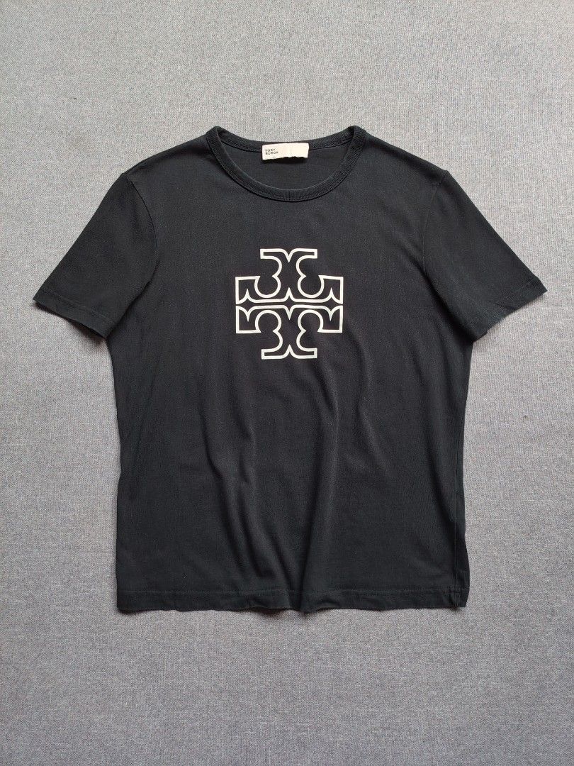 Tory Burch 'Double T' Logo Shirt (Category: Shirts) located in Taguig. Submitted by _theroom.ph (Listing ID 1465984591, Image 1). Description: - Brand: Tory Burch - Color: Black with large white graphic logo - Size: Medium (tag inside) - Material: Soft and breathable cotton - Design: Short sleeves, crew neck - Condition: Excellent for casual daily wear - Origin: Made in China Tory Burch 'Double T' Logo Shirt Size Medium 23 x 18 Excellent Conditio