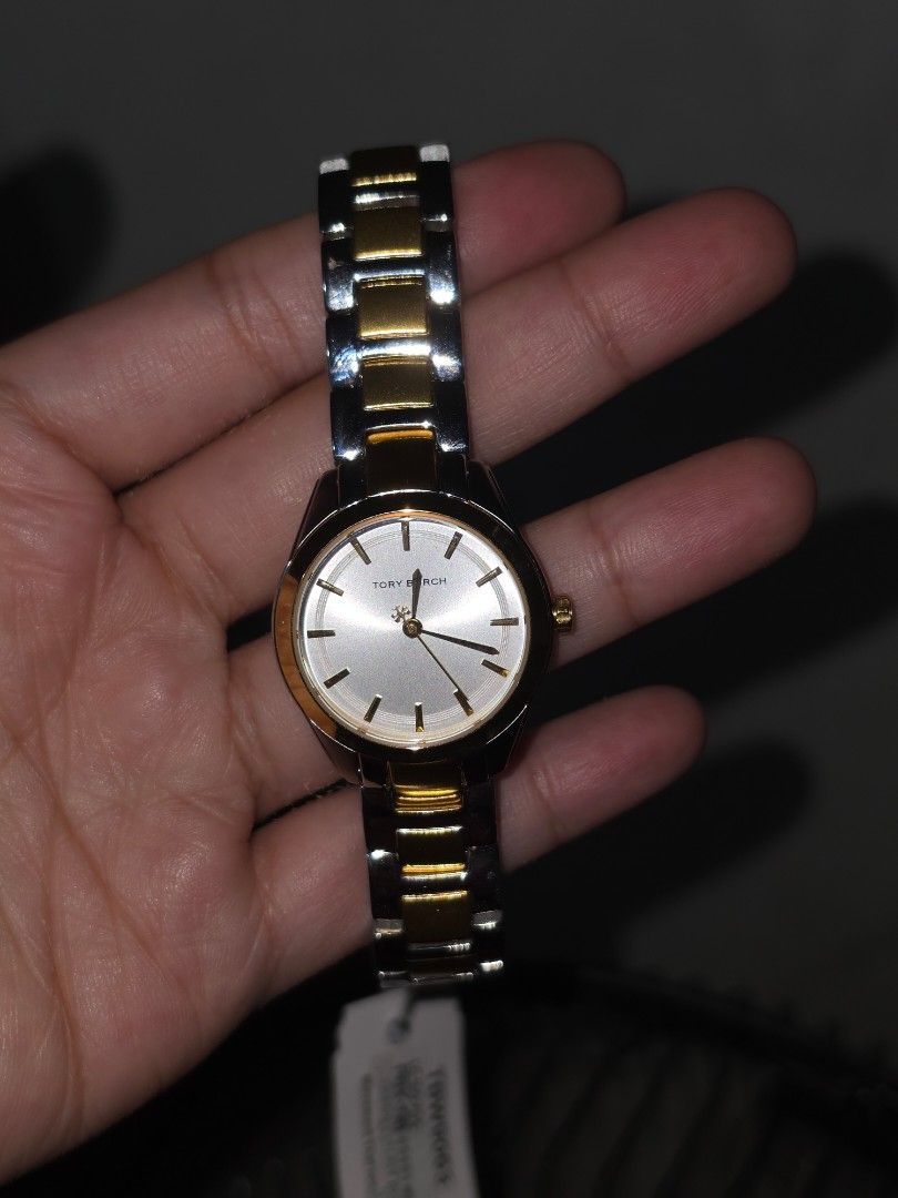 Tory Burch TBW9063 Two-Tone Watch (Category: Women's Watches) located in Manila. Submitted by _sj1204 (Listing ID 1466127618, Image 3). Description: - Brand: Tory Burch - Model: TBW9063 - Condition: Brand new and unworn, still attached to the original display cushion - Design: Two-tone bracelet in silver and gold with a round silver sunray dial - Inclusions: Original orange Tory Burch gift box and product tag included - Perfect for daily elegance