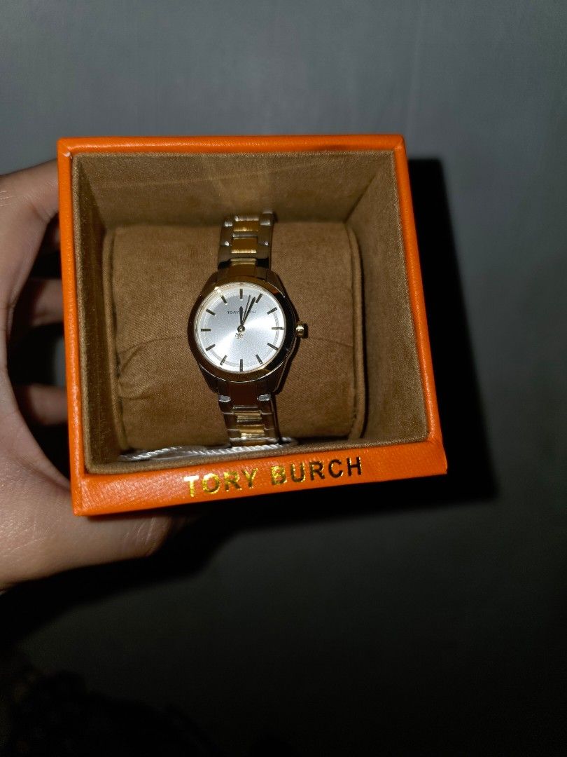Tory Burch TBW9063 Two-Tone Watch (Category: Women's Watches) located in Manila. Submitted by _sj1204 (Listing ID 1466127618, Image 1). Description: - Brand: Tory Burch - Model: TBW9063 - Condition: Brand new and unworn, still attached to the original display cushion - Design: Two-tone bracelet in silver and gold with a round silver sunray dial - Inclusions: Original orange Tory Burch gift box and product tag included - Perfect for daily elegance