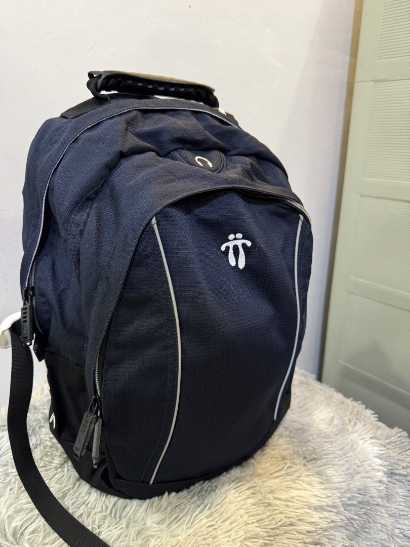 Totto Black Backpack with Durable Handle (Category: Backpacks) located in Urdaneta. Submitted by kathleenja24136 (Listing ID 1465958071, Image 2). Description: Totto black backpack with white logo embroidery on the front and back straps. Sturdy molded handle on top for easy carrying. Padded shoulder straps include reflective strips and logo branding. Multiple zip compartments and durable fabric construction. Great daily pack for school, work, or 