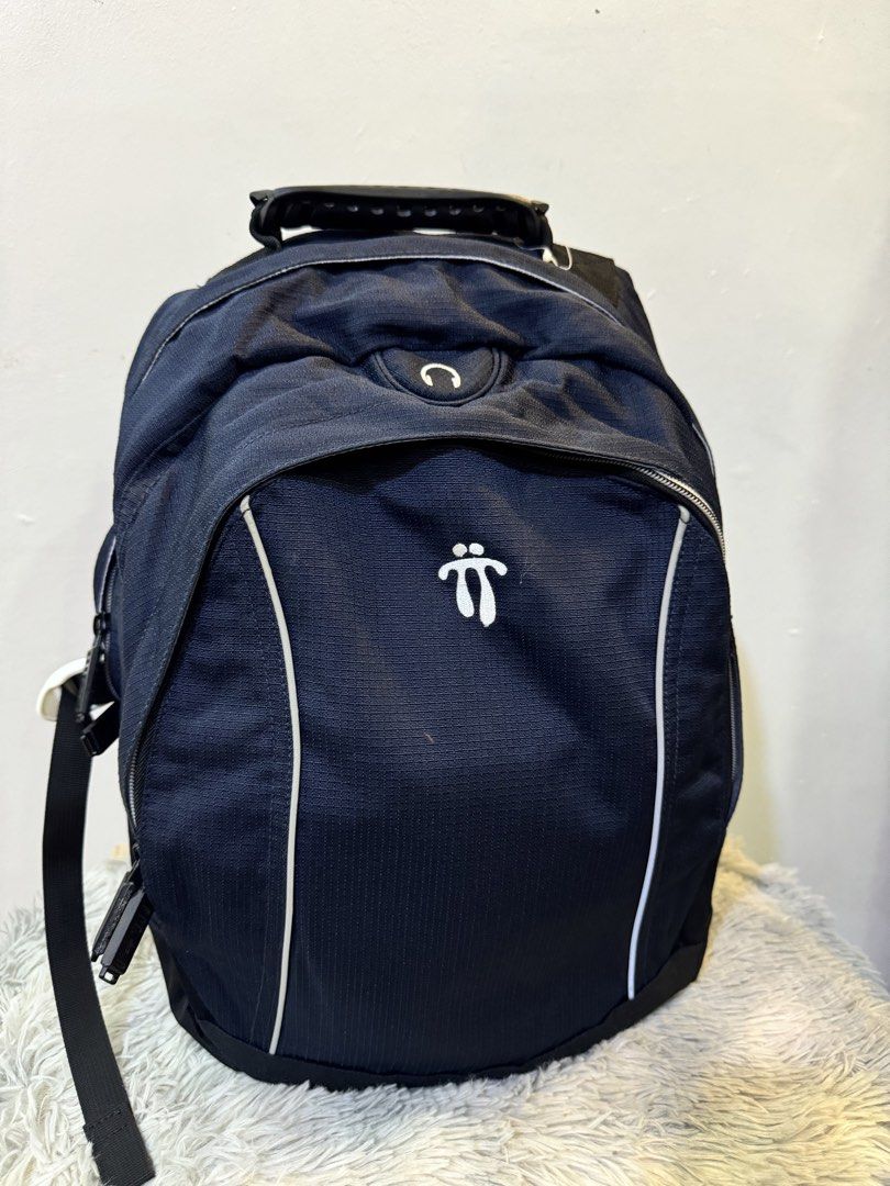 Totto Black Backpack with Durable Handle (Category: Backpacks) located in Urdaneta. Submitted by kathleenja24136 (Listing ID 1465958071, Image 1). Description: Totto black backpack with white logo embroidery on the front and back straps. Sturdy molded handle on top for easy carrying. Padded shoulder straps include reflective strips and logo branding. Multiple zip compartments and durable fabric construction. Great daily pack for school, work, or 